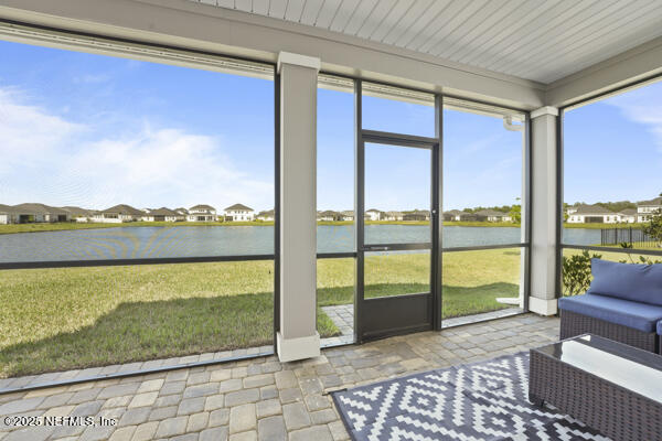 73 Lily Landing Dr, Saint Augustine, FL 32092 - sunroom featuring a water view and stone finish floor