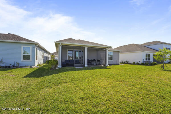 73 Lily Landing Dr, Saint Augustine, FL 32092 - back of house with a sunroom and a yard