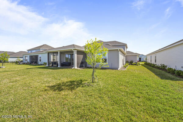 73 Lily Landing Dr, Saint Augustine, FL 32092 - back of house featuring a lawn