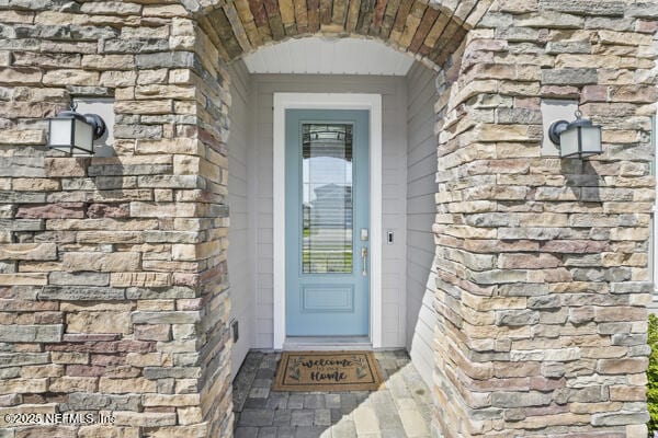 73 Lily Landing Dr, Saint Augustine, FL 32092 - doorway to property featuring stone siding