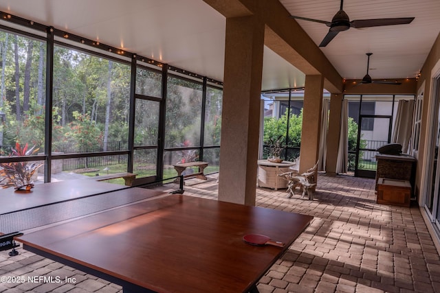 sunroom / solarium with brick floor and floor to ceiling windows