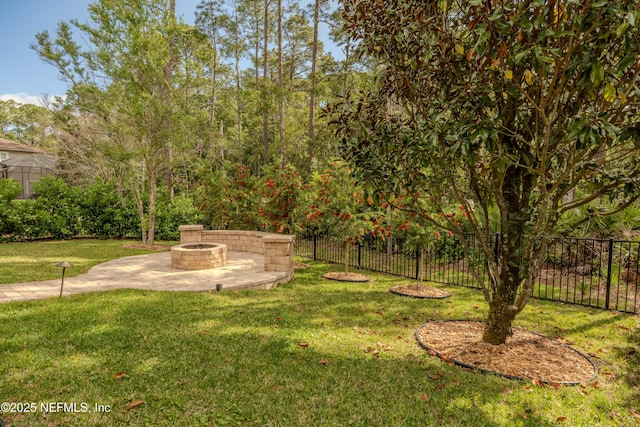 view of yard featuring a patio, fence, and an outdoor fire pit