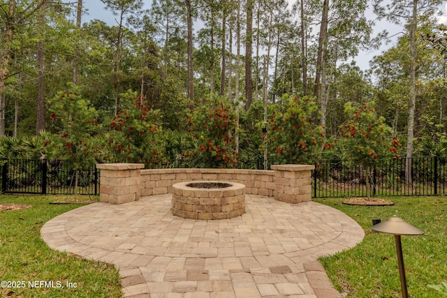 view of patio / terrace featuring fence and an outdoor fire pit