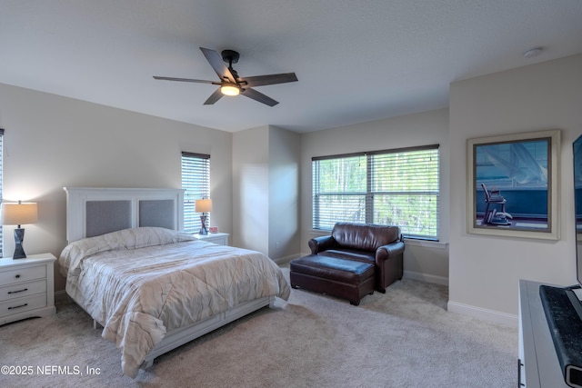 bedroom with baseboards, carpet flooring, and a ceiling fan