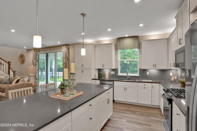 75 Mallow Ct, Saint Johns, FL 32259 - kitchen featuring a sink, a healthy amount of sunlight, dark countertops, and stainless steel appliances