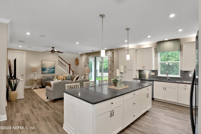 75 Mallow Ct, Saint Johns, FL 32259 - kitchen featuring backsplash, dark countertops, a wealth of natural light, and a sink