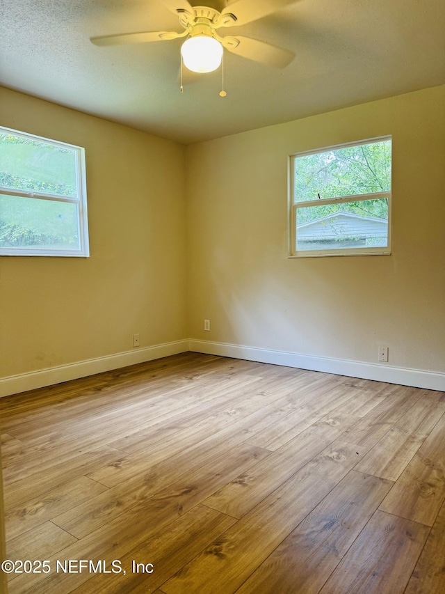 2443 Pine Estates Rd E, Jacksonville, FL 32218 - spare room featuring wood finished floors, ceiling fan, and baseboards