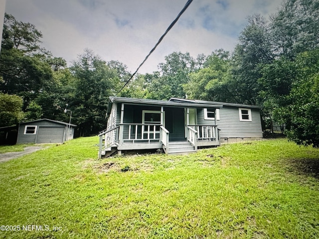 2443 Pine Estates Rd E, Jacksonville, FL 32218 - manufactured / mobile home featuring a front yard, covered porch, crawl space, a garage, and an outdoor structure