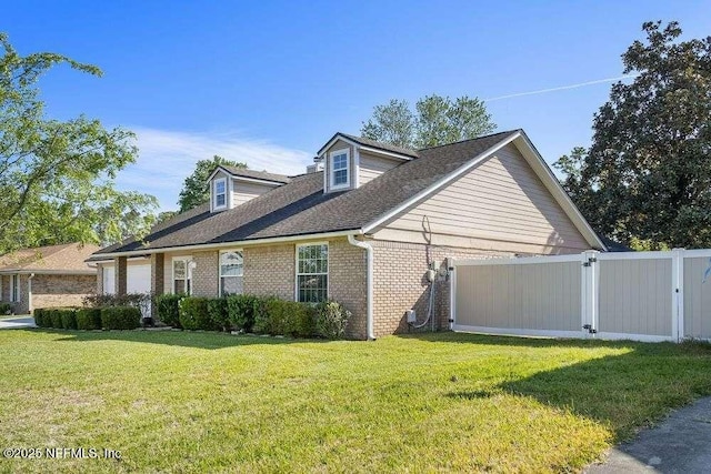 601 Robert Livingston St, Orange Park, FL 32073 - view of property exterior with brick siding, fence, a lawn, and a gate