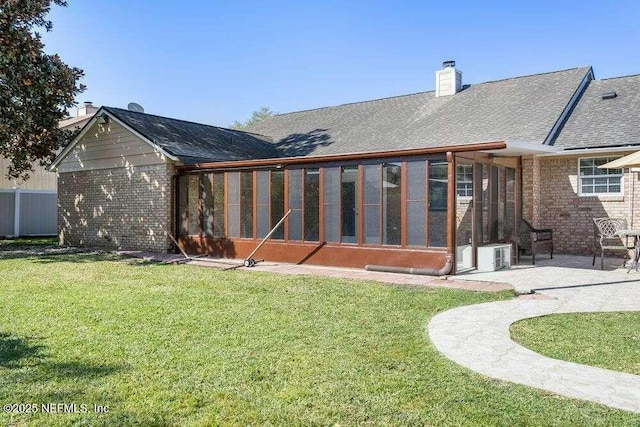 601 Robert Livingston St, Orange Park, FL 32073 - back of house with a sunroom, a yard, a patio area, and a chimney