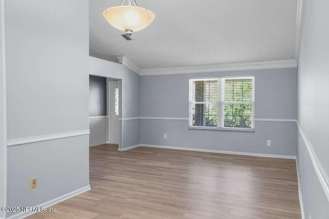 601 Robert Livingston St, Orange Park, FL 32073 - unfurnished room featuring ornamental molding, baseboards, wood finished floors, and a textured ceiling