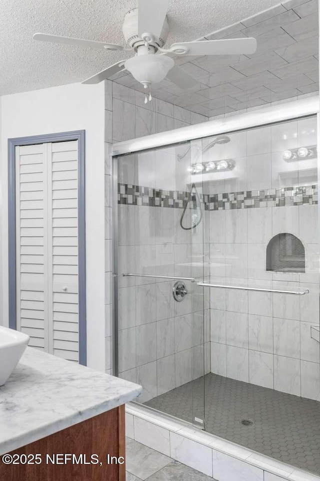 601 Robert Livingston St, Orange Park, FL 32073 - full bathroom featuring a shower stall, a textured ceiling, vanity, and a ceiling fan