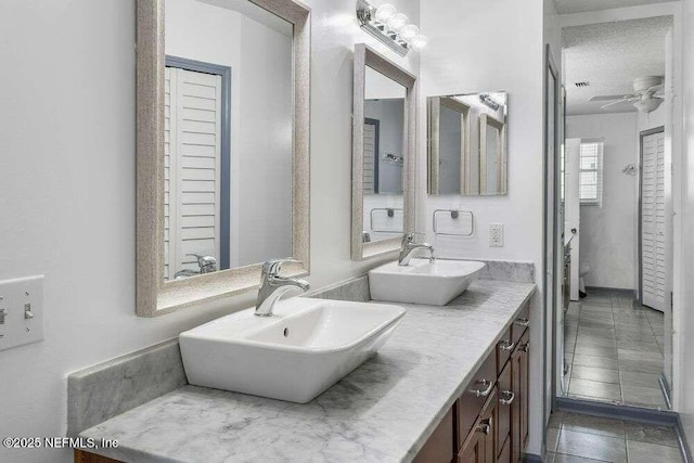 601 Robert Livingston St, Orange Park, FL 32073 - full bathroom with double vanity, a sink, and a ceiling fan