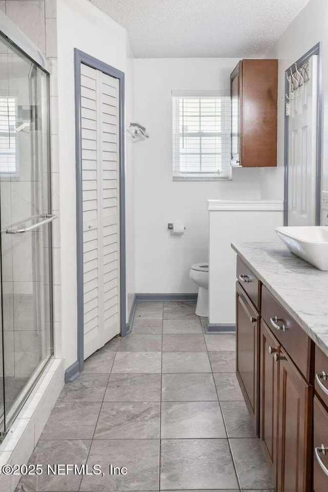 601 Robert Livingston St, Orange Park, FL 32073 - bathroom featuring toilet, a textured ceiling, and a stall shower