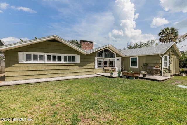 6960 Charles St, Saint Augustine, FL 32080 - rear view of property with a yard and a chimney