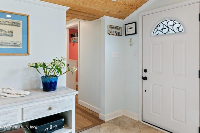 6960 Charles St, Saint Augustine, FL 32080 - entryway with baseboards, light tile patterned floors, crown molding, lofted ceiling, and wood ceiling
