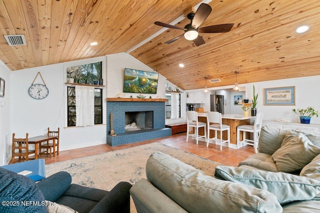 6960 Charles St, Saint Augustine, FL 32080 - tiled living area with a fireplace, a ceiling fan, visible vents, lofted ceiling, and wood ceiling