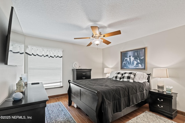 bedroom with wood finished floors, baseboards, and a ceiling fan