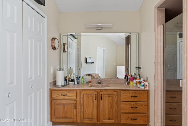 bathroom featuring vanity and a closet