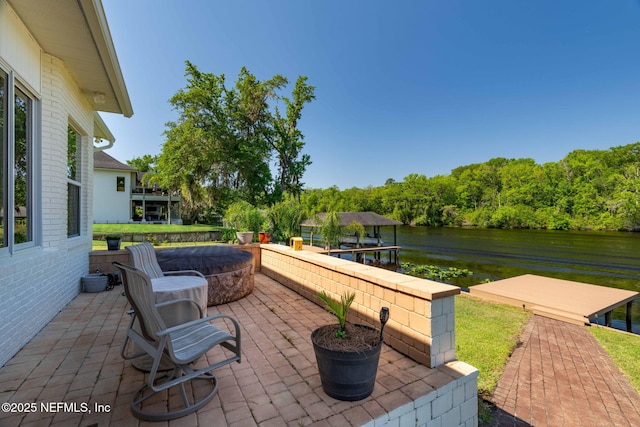 view of patio / terrace featuring a water view and an outdoor fire pit