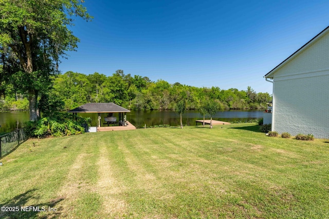 view of yard with fence and a water view
