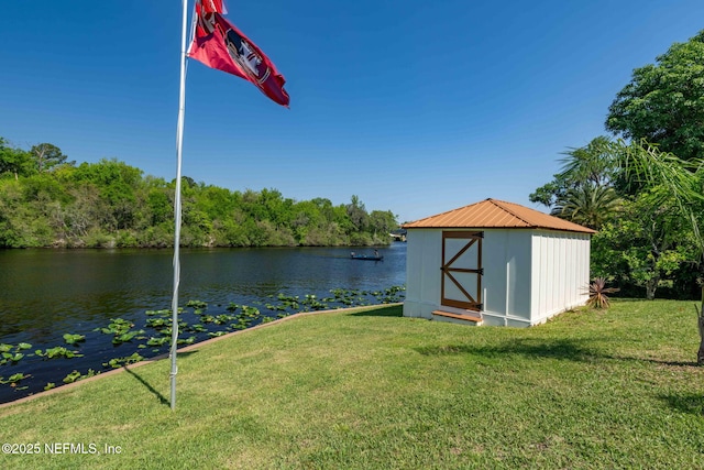 exterior space with a storage shed, an outdoor structure, and a water view