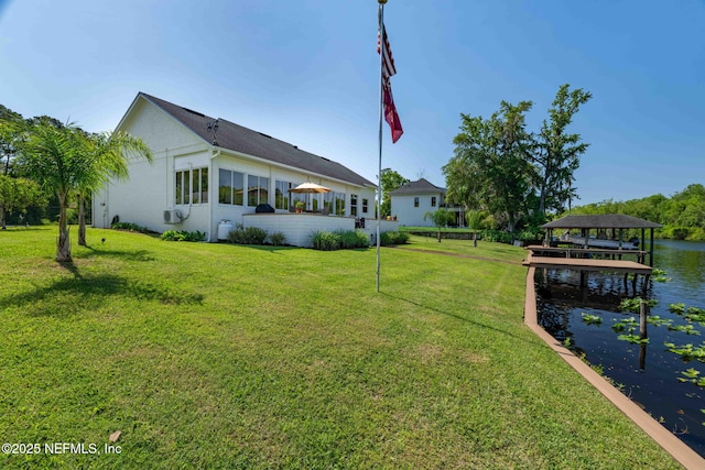 back of property featuring a water view and a yard