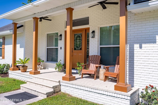 property entrance featuring brick siding, a porch, and a ceiling fan