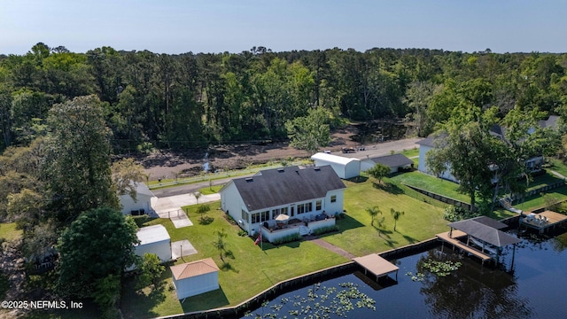 drone / aerial view featuring a wooded view and a water view