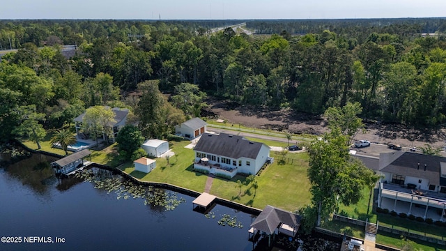 drone / aerial view with a wooded view and a water view