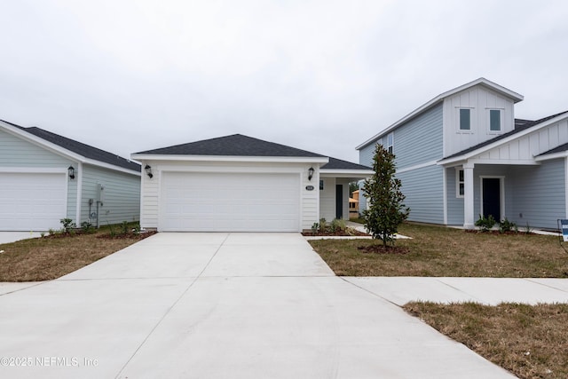 view of front facade with an attached garage, board and batten siding, and driveway