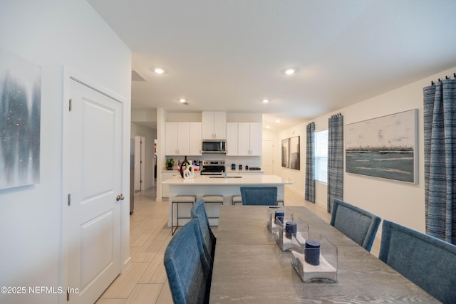 dining space featuring recessed lighting and wood finish floors