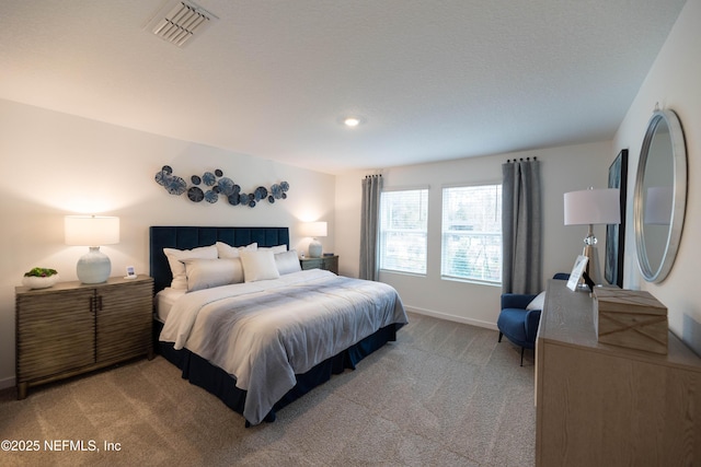 bedroom with light colored carpet, baseboards, and visible vents