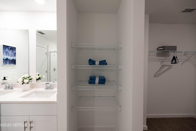 closet with a sink and visible vents