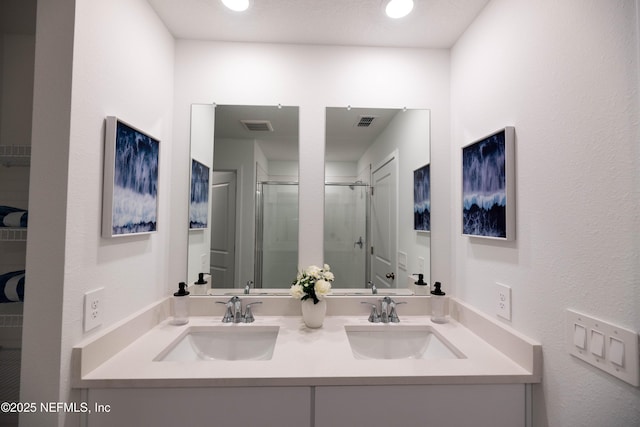 full bathroom featuring a sink, visible vents, and a shower stall