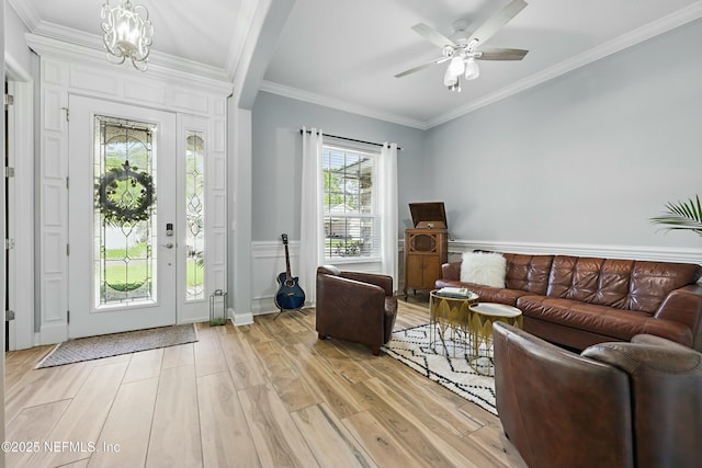 105 Weathered Oak Ct, Saint Johns, FL 32259 - living room with a chandelier, light wood-style flooring, crown molding, and a ceiling fan