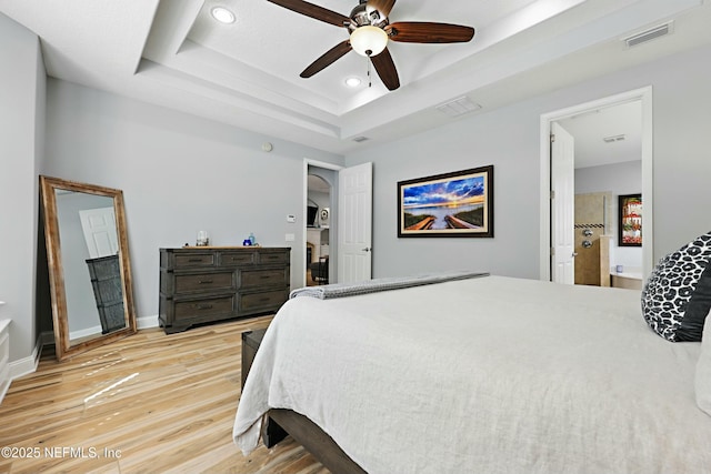 105 Weathered Oak Ct, Saint Johns, FL 32259 - bedroom with light wood-type flooring, recessed lighting, a raised ceiling, arched walkways, and a ceiling fan