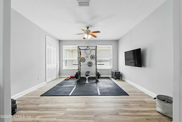 105 Weathered Oak Ct, Saint Johns, FL 32259 - workout area featuring wood finished floors, ceiling fan, and a textured ceiling