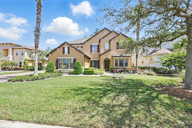 view of front of house featuring a front yard and stucco siding