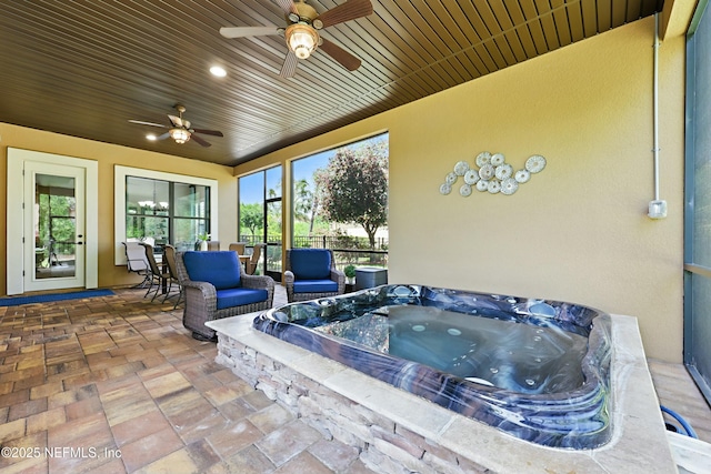 sunroom / solarium with a hot tub