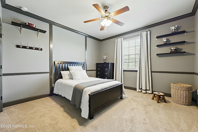 bedroom with ornamental molding, baseboards, a ceiling fan, and light colored carpet