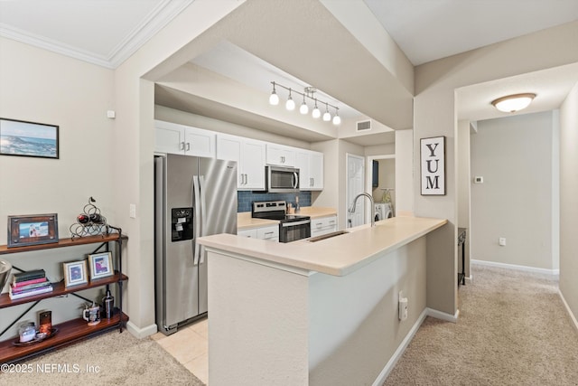 10075 N Gate Pkwy Unit 614, Jacksonville, FL 32246 - kitchen with a peninsula, visible vents, white cabinets, appliances with stainless steel finishes, and a sink