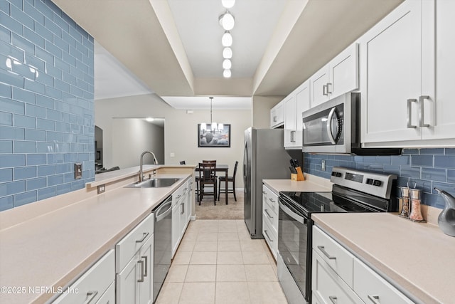 10075 N Gate Pkwy Unit 614, Jacksonville, FL 32246 - kitchen featuring white cabinetry, appliances with stainless steel finishes, light countertops, a sink, and decorative backsplash