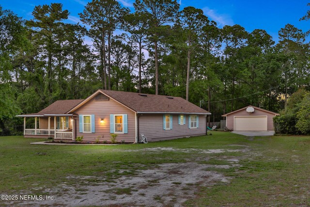 4864 County Road 218, Middleburg, FL 32068 - view of front of home with an outbuilding, a detached garage, a porch, and a front yard