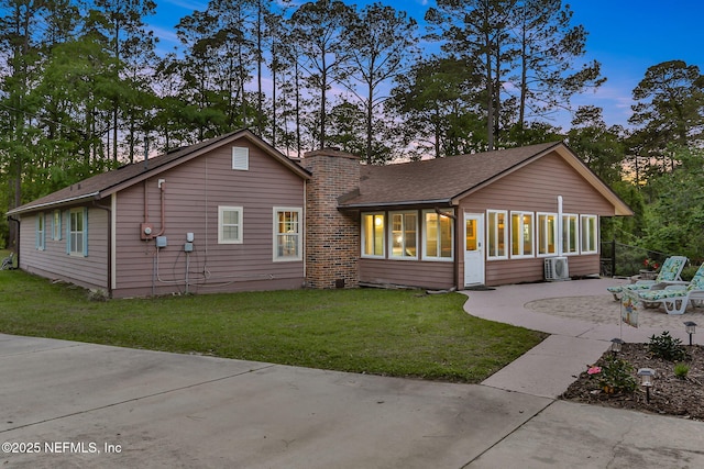 4864 County Road 218, Middleburg, FL 32068 - exterior space featuring a chimney, a front lawn, a patio area, a sunroom, and a shingled roof