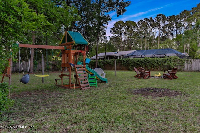 4864 County Road 218, Middleburg, FL 32068 - view of jungle gym with a fire pit, fence, and a lawn