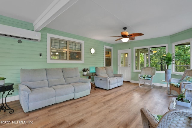 4864 County Road 218, Middleburg, FL 32068 - living area with wood finished floors, a wall mounted air conditioner, ceiling fan, and baseboards