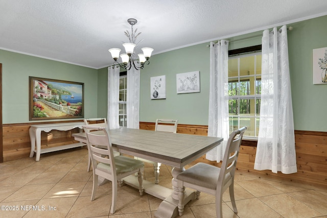 4864 County Road 218, Middleburg, FL 32068 - dining area with a textured ceiling, ornamental molding, a chandelier, wood walls, and wainscoting