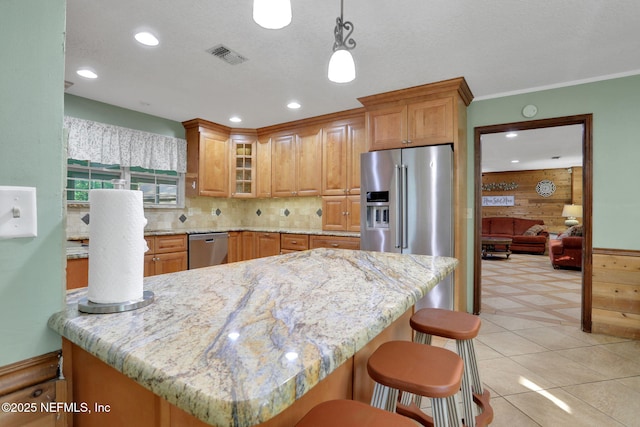 4864 County Road 218, Middleburg, FL 32068 - kitchen with visible vents, appliances with stainless steel finishes, glass insert cabinets, and light stone counters