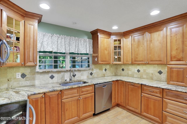 4864 County Road 218, Middleburg, FL 32068 - kitchen with tasteful backsplash, light stone counters, brown cabinets, dishwasher, and a sink